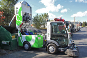 Dulevo d.zero2 Electric Street Sweeper emptying into dumpster