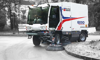 Dulevo 6000 Street Sweeper cleaning around the curb of a road