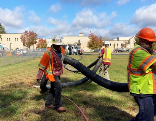 Camel 1200 Sewer Cleaner Truck - Workers carrying hose