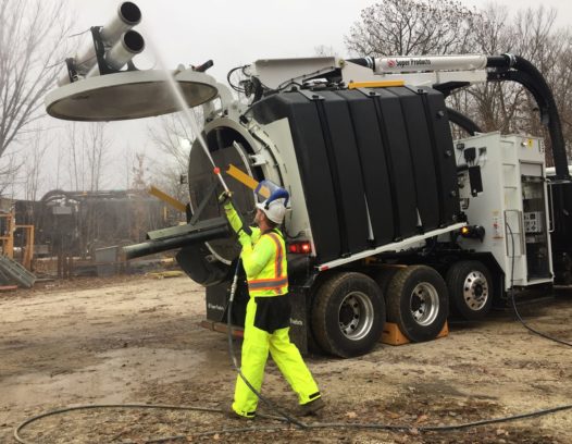 Cleaning off a Mud Dog 1200 Vacuum Excavator with its spray hose