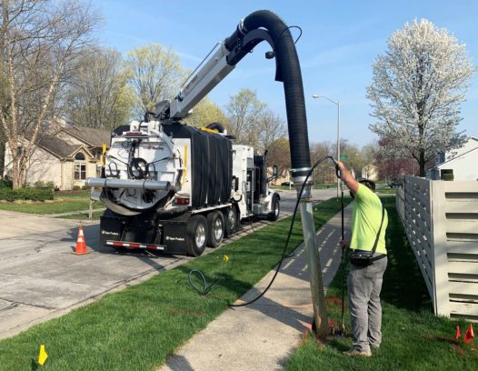 Mud Dog 1200 Hydro Excavator digging to a buried utility in a neighborhood