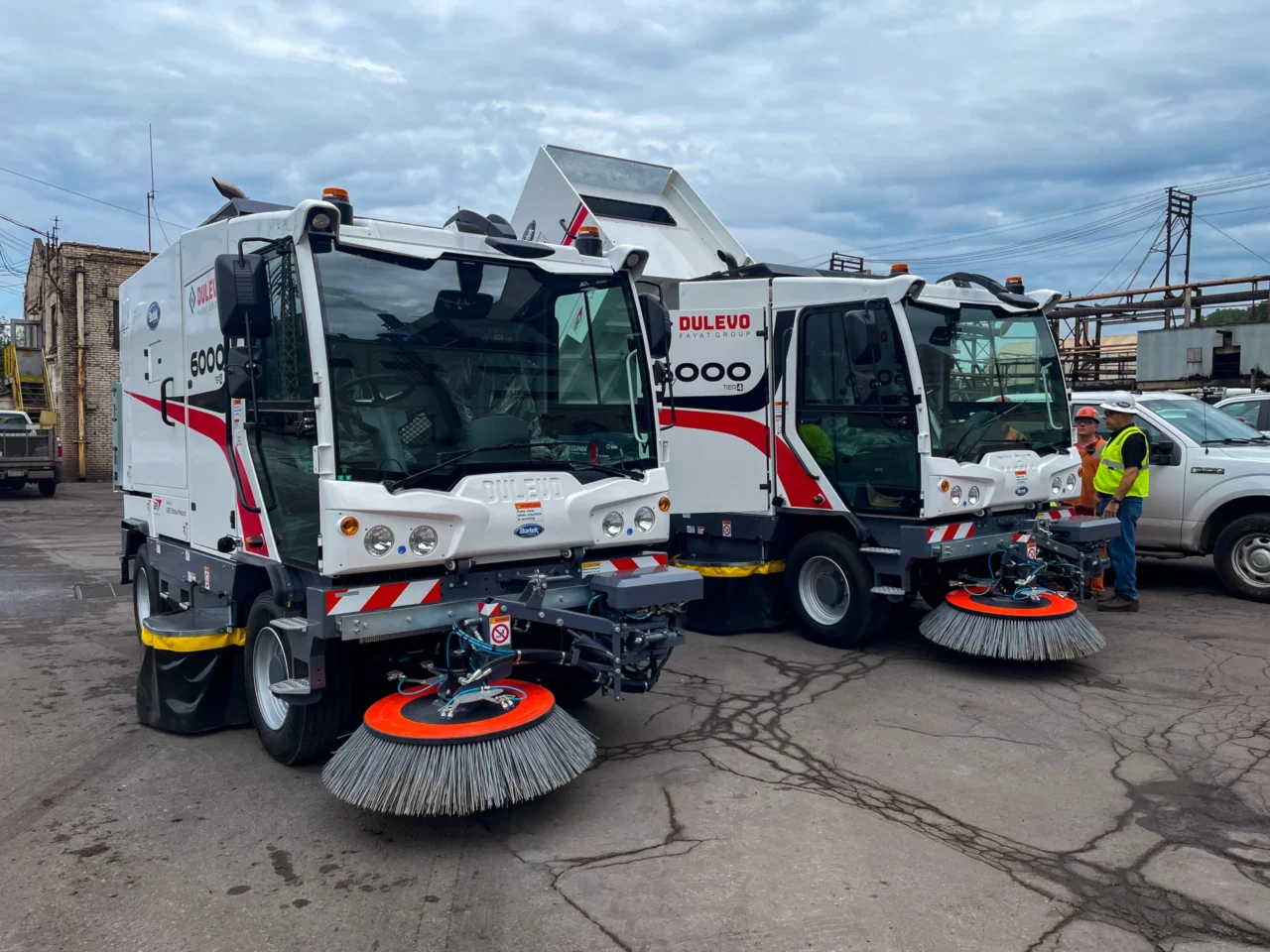 Mechanical street sweeper cleaning a road