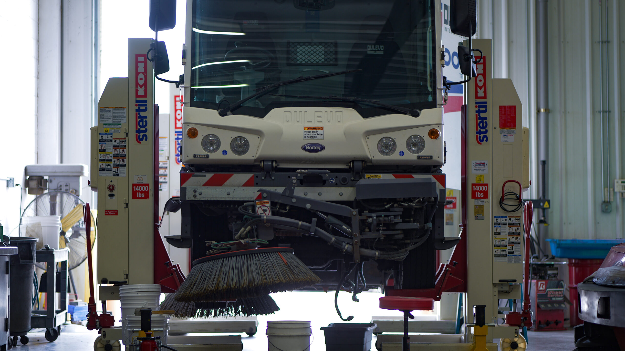 Bortek technician servicing a street sweeper